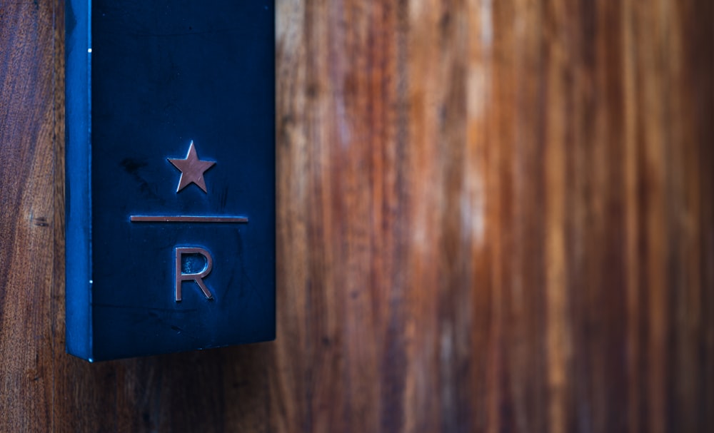 a wooden wall with a metal sign on it