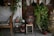 Industrial metal plant stand displaying multiple potted plants in a cozy living room corner.