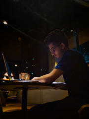 A person filling out an onboarding form on a laptop with warm lighting.