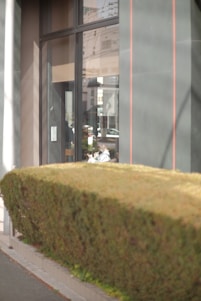 An energy consultant working on a tablet in front of a modern residential building with digital energy diagrams overlay.