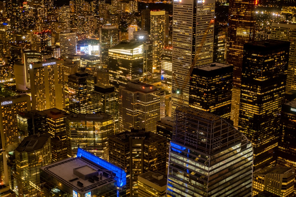 a view of a city at night from the top of a skyscraper