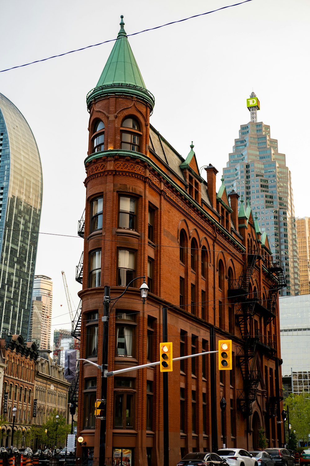 a large red brick building with a green roof