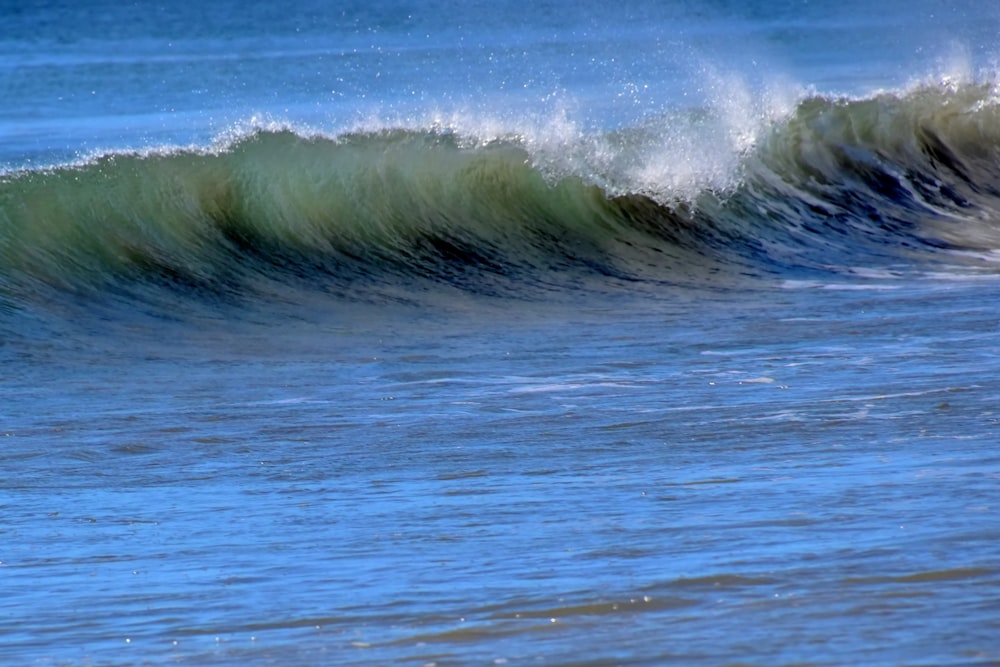 a man riding a wave on top of a surfboard