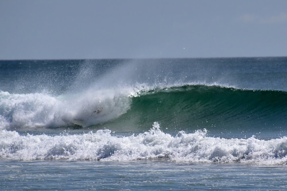 a person riding a wave on top of a surfboard