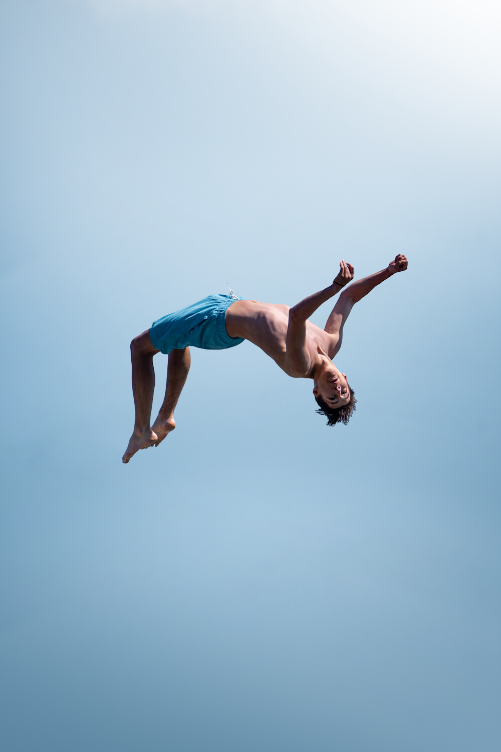 a man in the air doing a trick on a surfboard