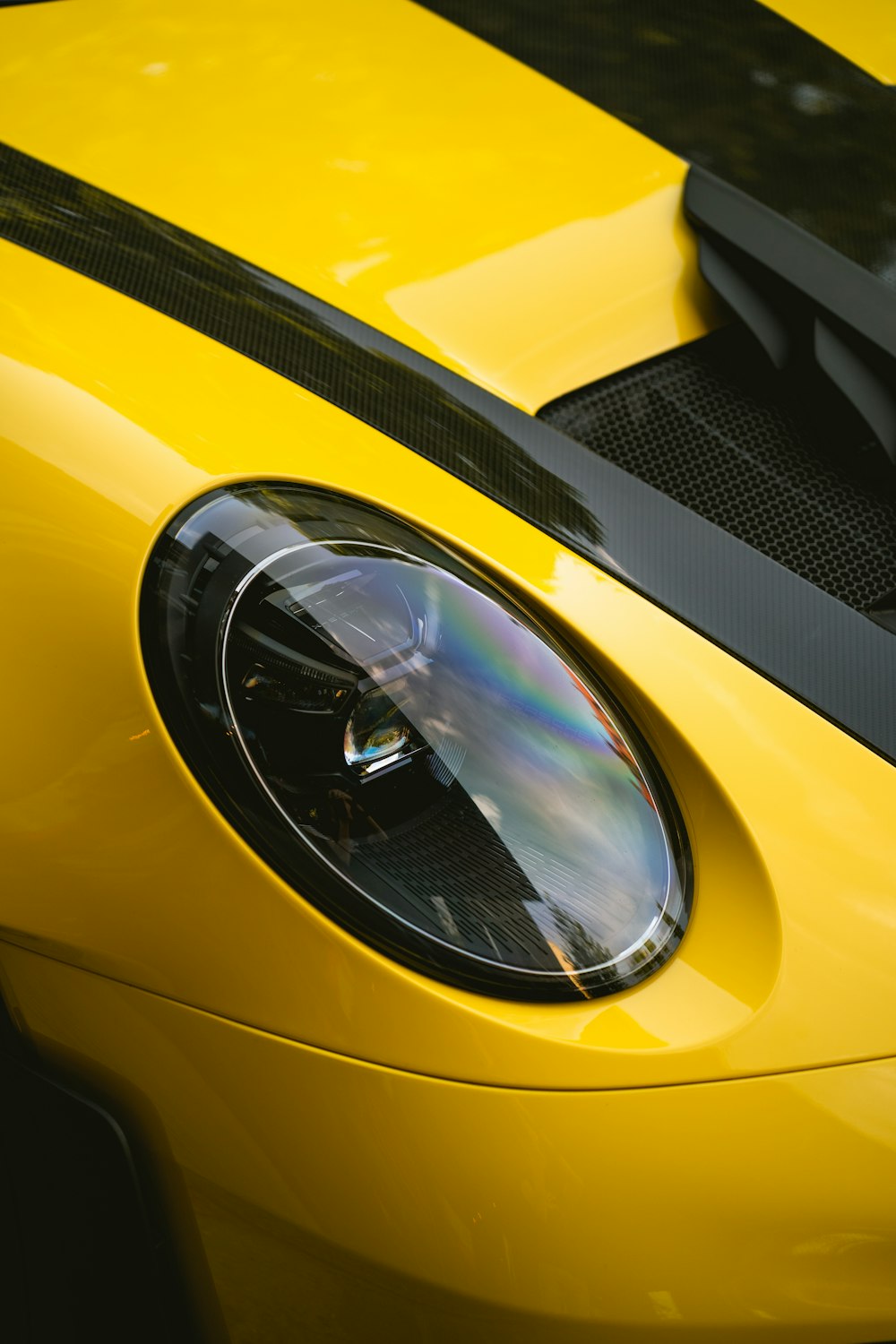 a close up of the front of a yellow sports car