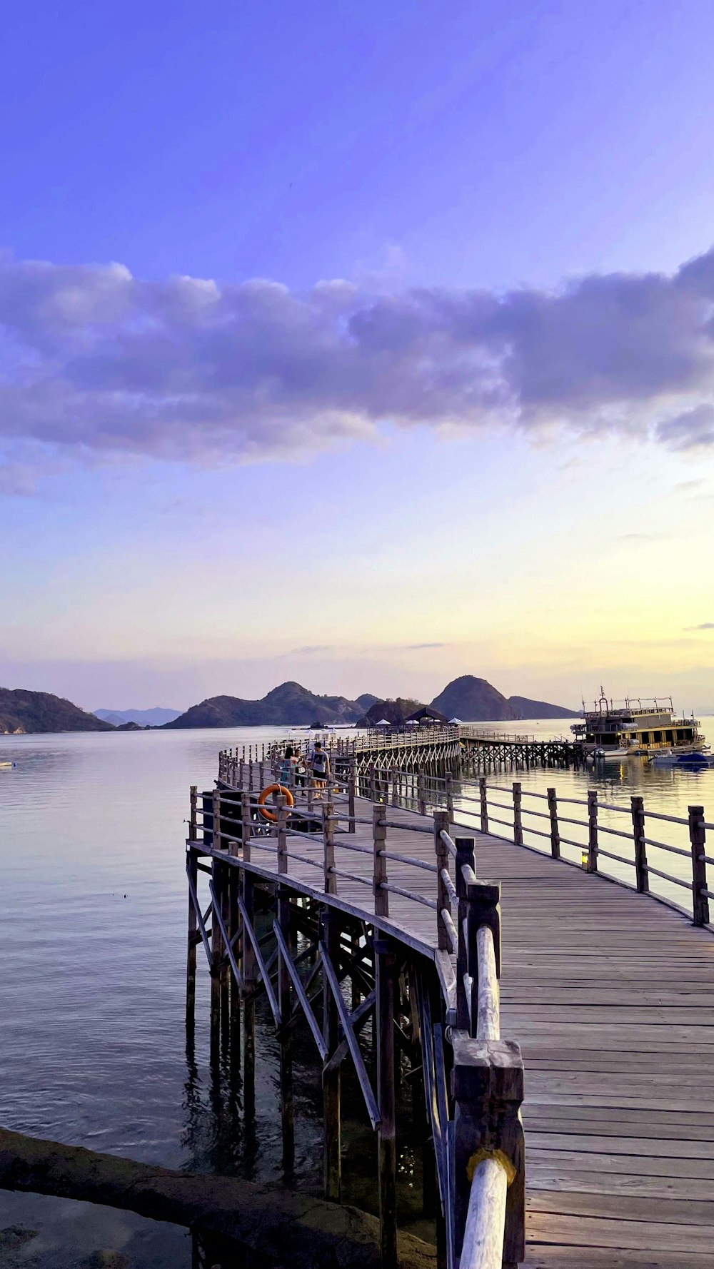 a pier with a boat in the water