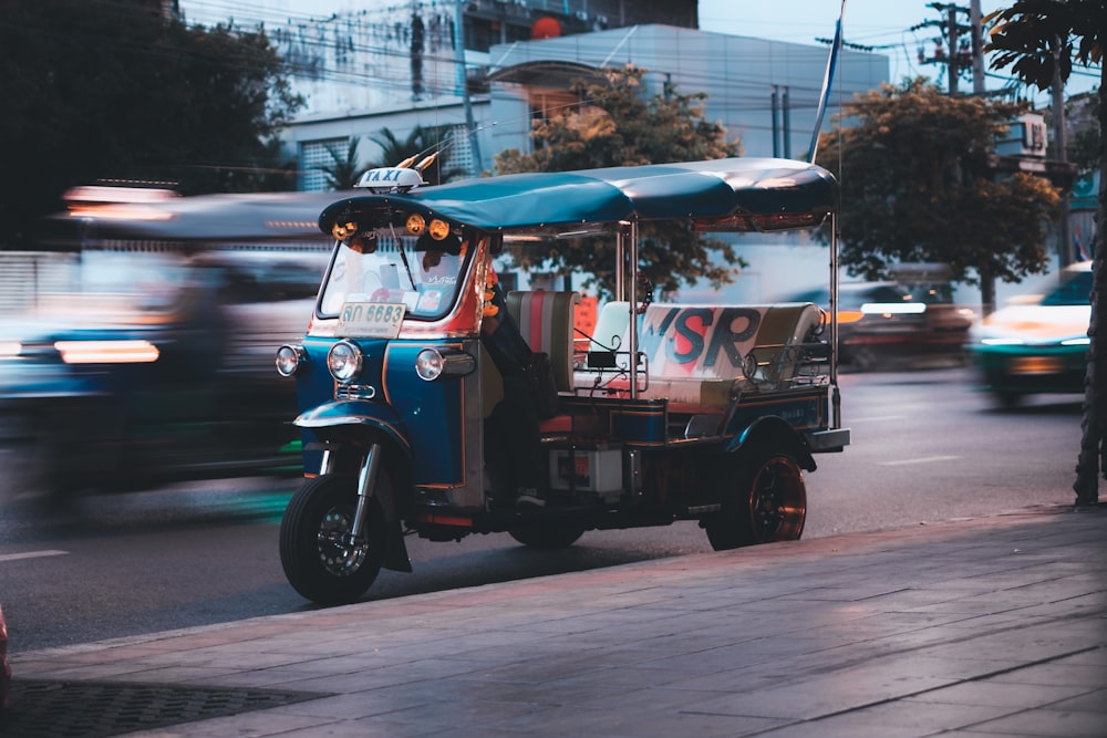 a tuk tuk is driving down the street