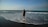a person standing in the water at the beach
