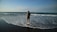 a person standing in the water at the beach