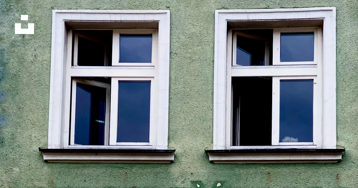 A green building with a white umbrella outside of it photo – Free ...