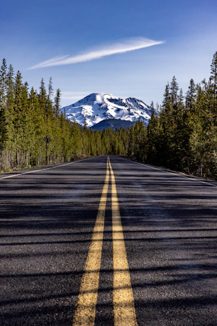 a road with a mountain in the background