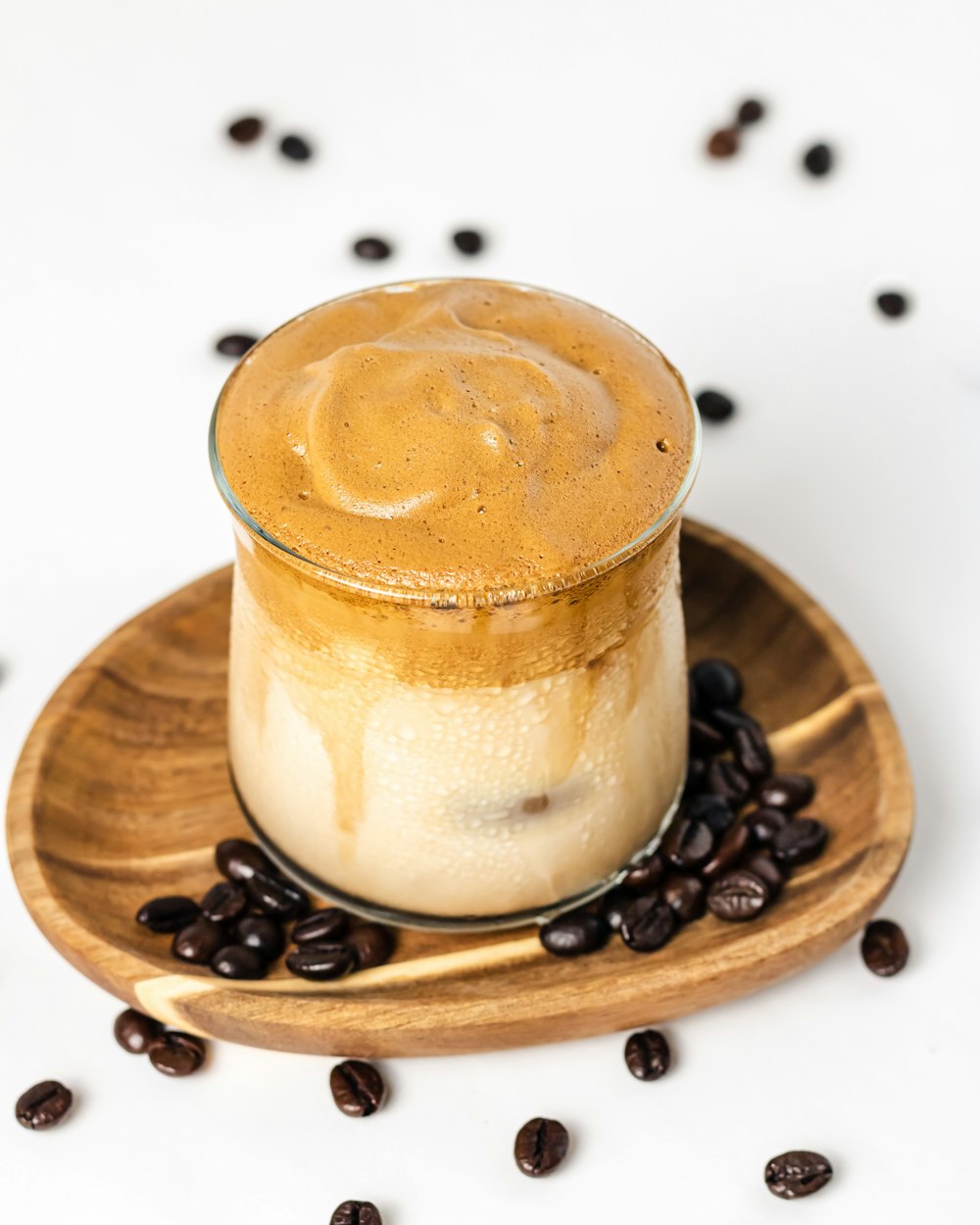 a cup of coffee sitting on top of a wooden plate