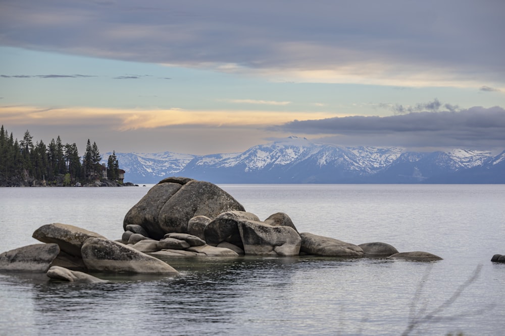 a large rock in the middle of a body of water