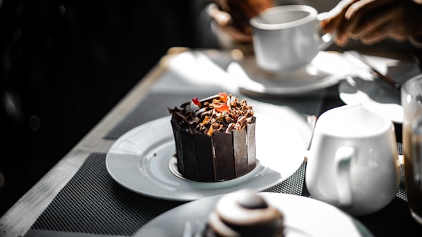 a chocolate cake sitting on top of a white plate