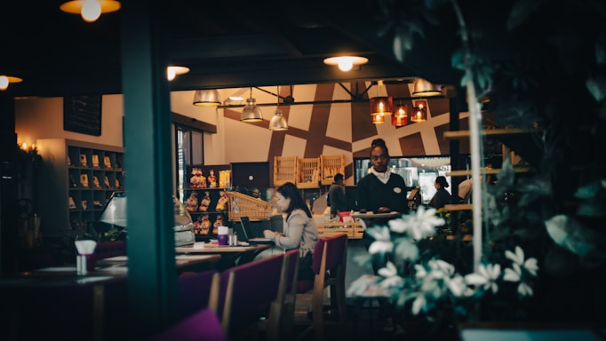 Cozy coastal restaurant interior with warm lighting and inviting tables.