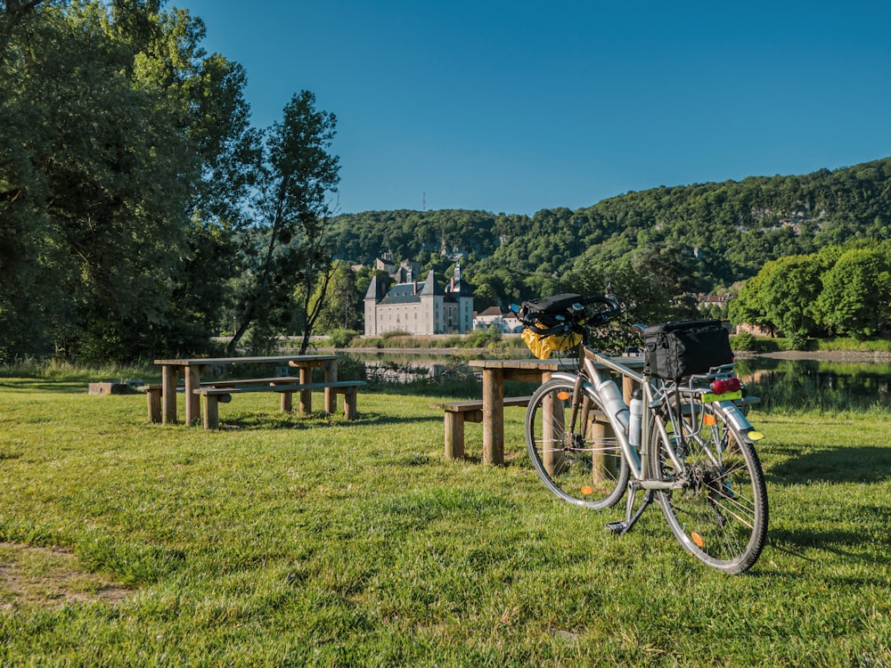 a bicycle parked next to a picnic table