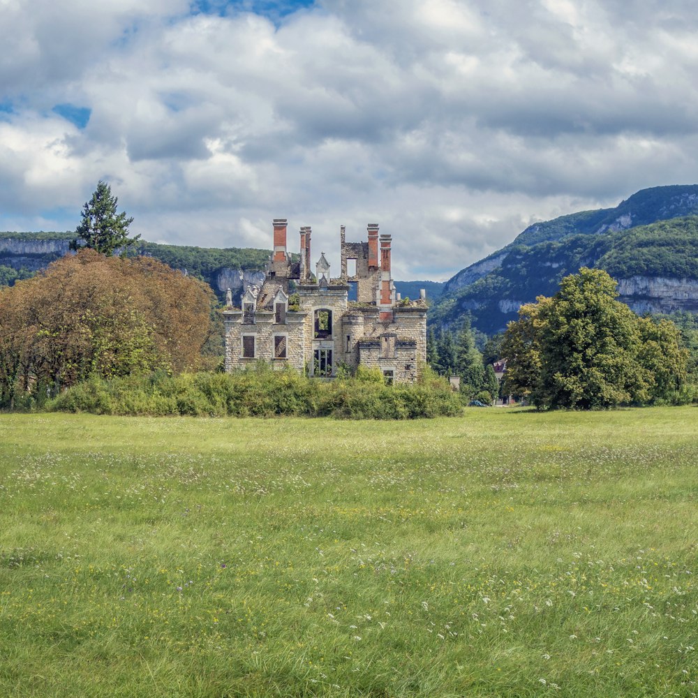 a large building sitting on top of a lush green field