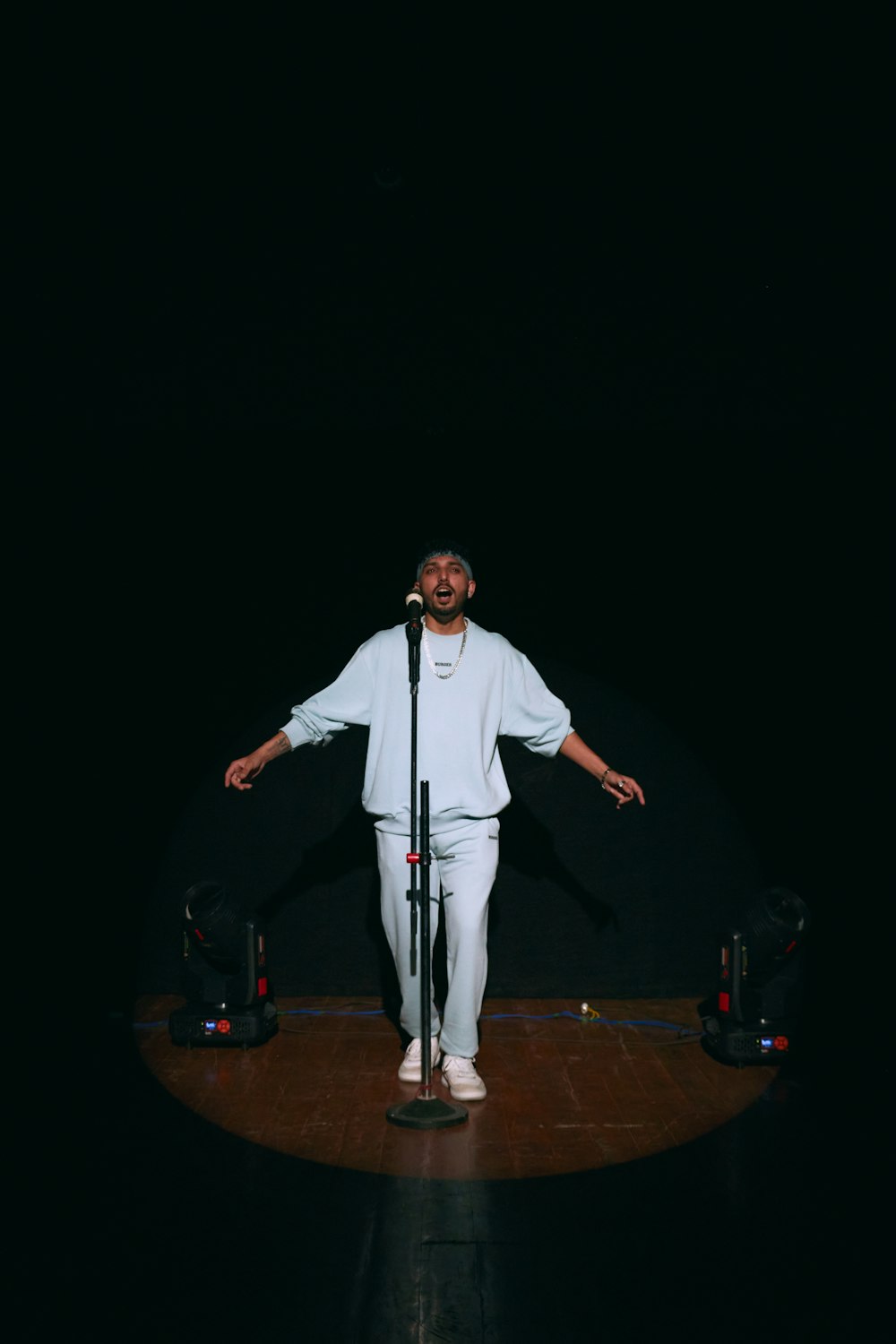 a man standing on a stage with a microphone