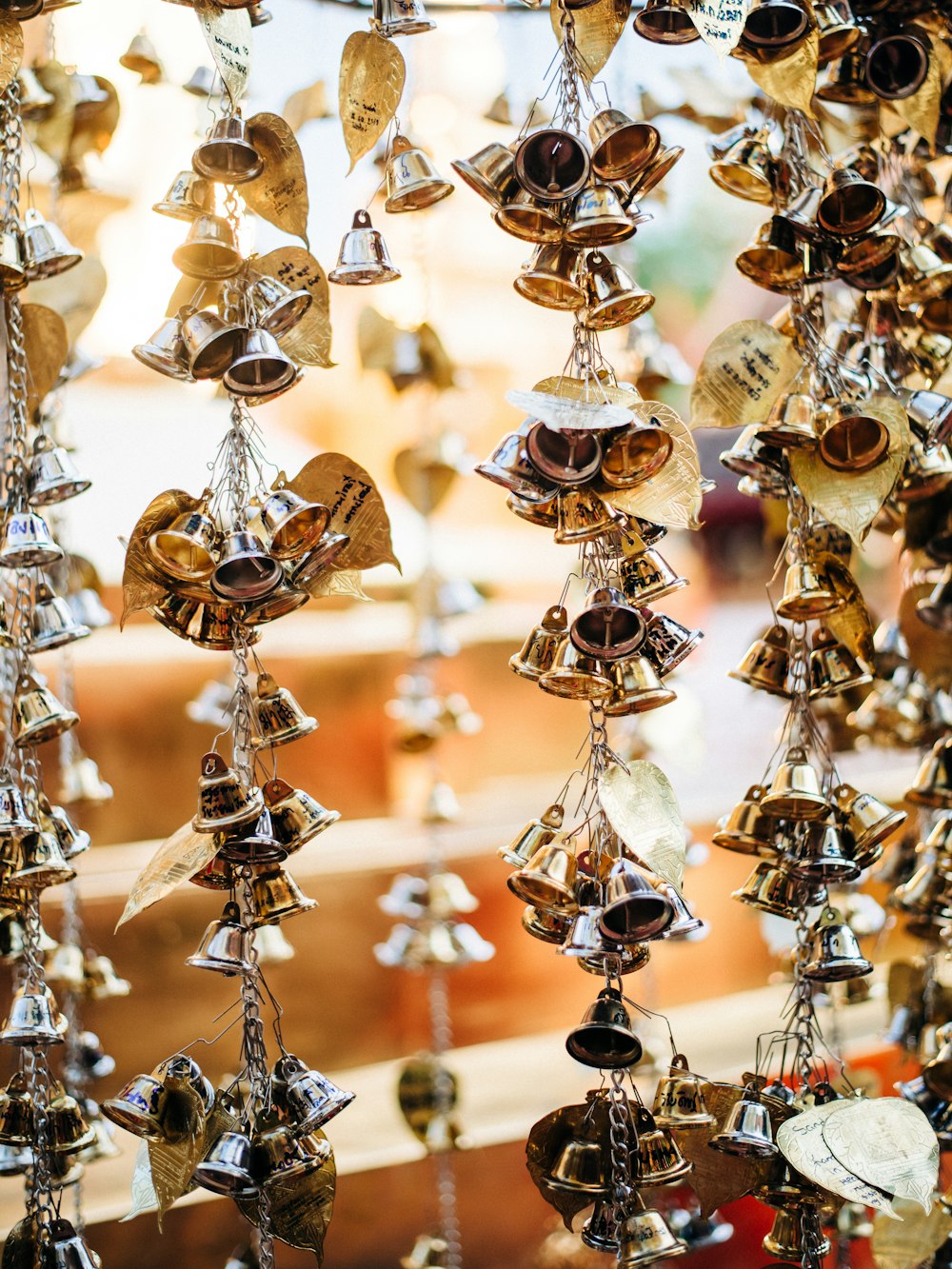 a group of bells hanging from a ceiling