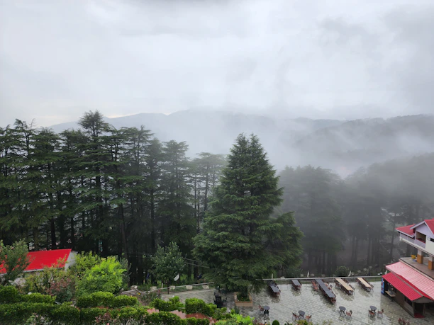 A serene mountain cottage patio overlooking a misty valley at sunrise.