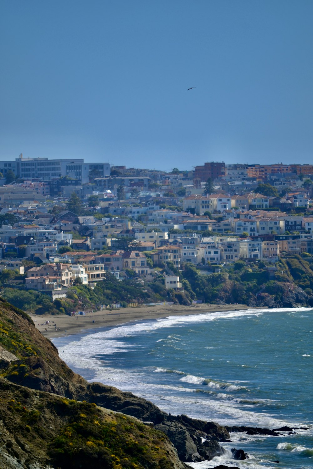 a view of a beach with a city in the background