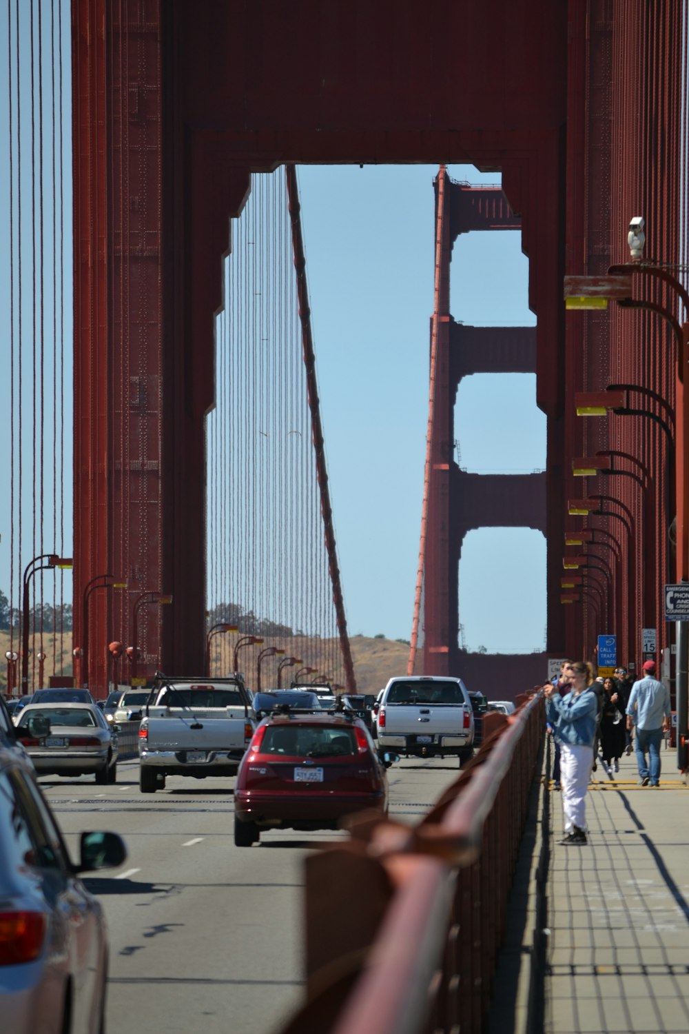 a group of people walking across a bridge