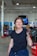 a woman holding a wrench in a garage