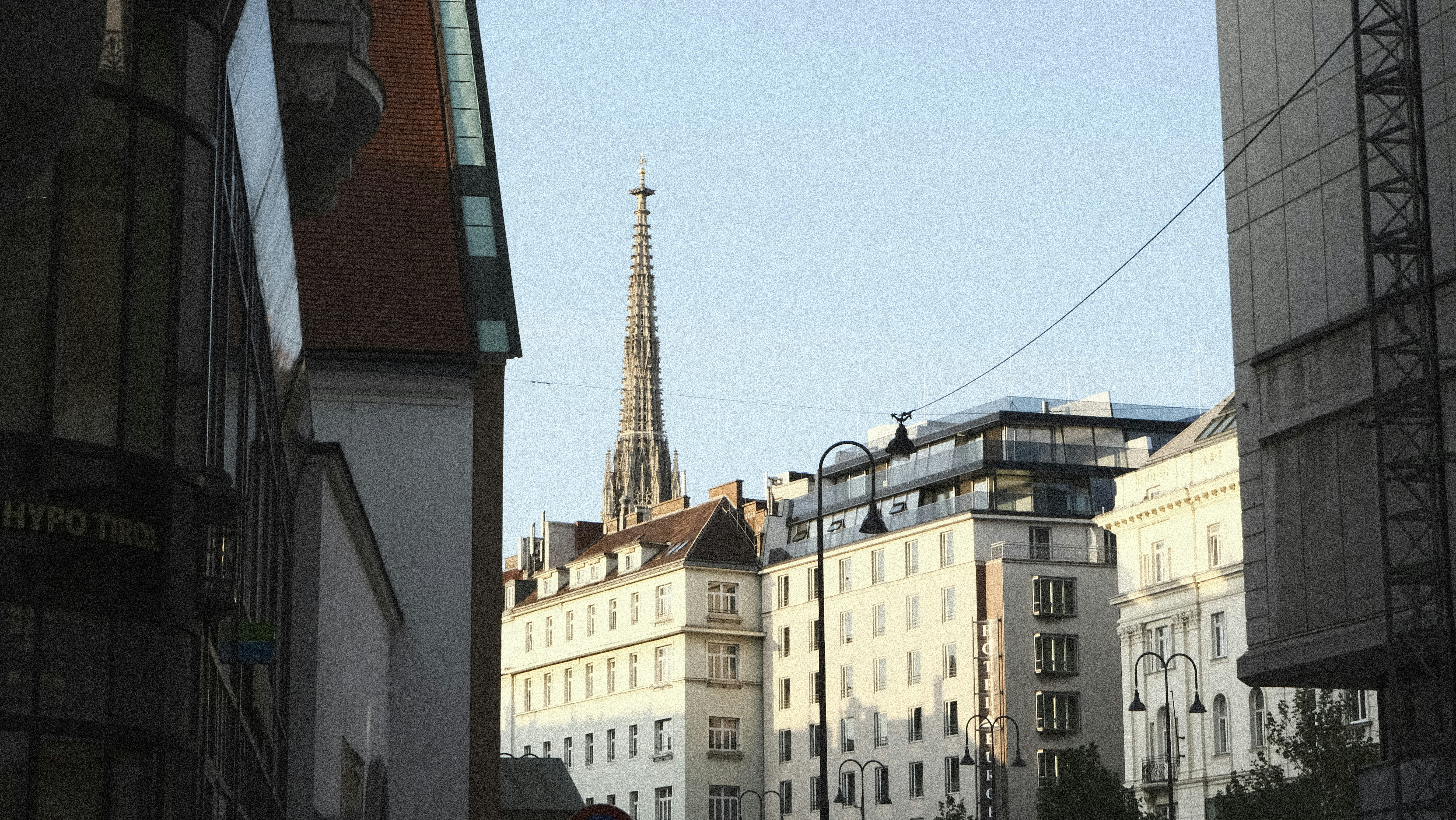 a city street with buildings and a clock tower in the background