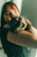 A warm, candid photo of a smiling cat owner holding their content feline companion.