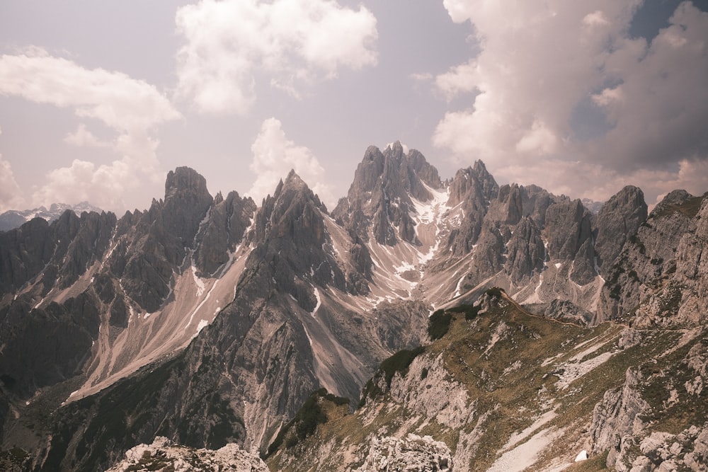 a view of a mountain range from the top of a hill