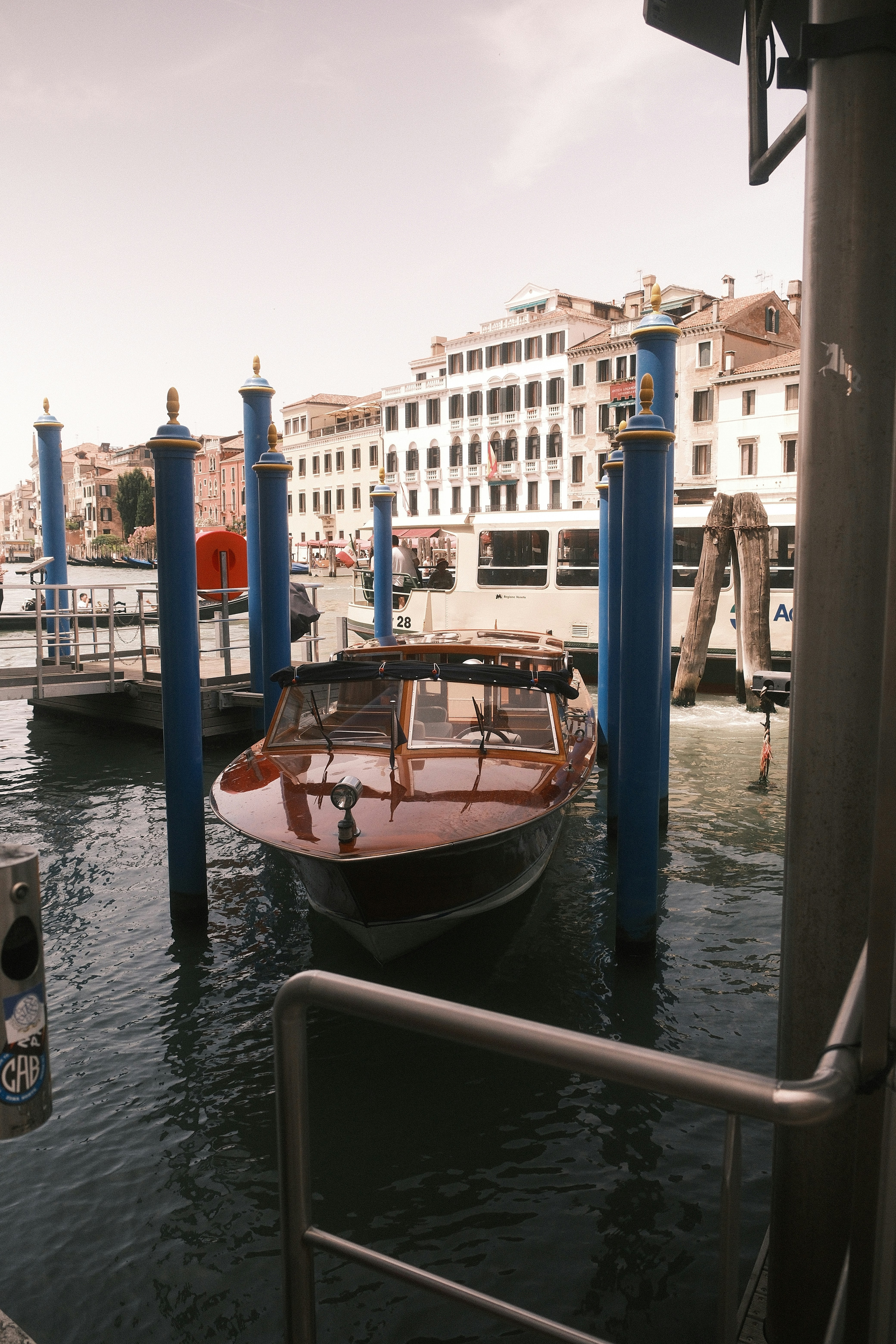 a boat docked at a dock in a city