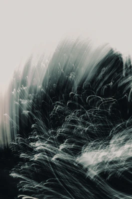 Monochrome abstract waves blending into soft blurred gradients, evoking a cinematic mood.