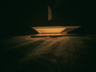 A nighttime scene with an lptun laptop screen glowing softly in a cozy room.