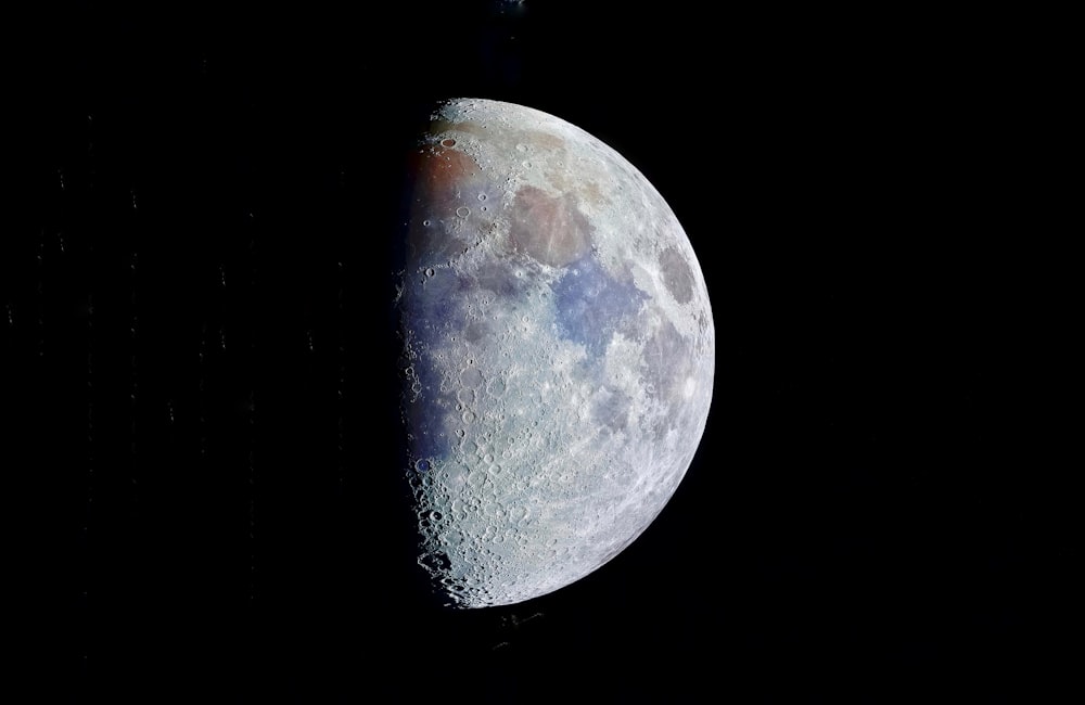 a close up of the moon in the dark sky