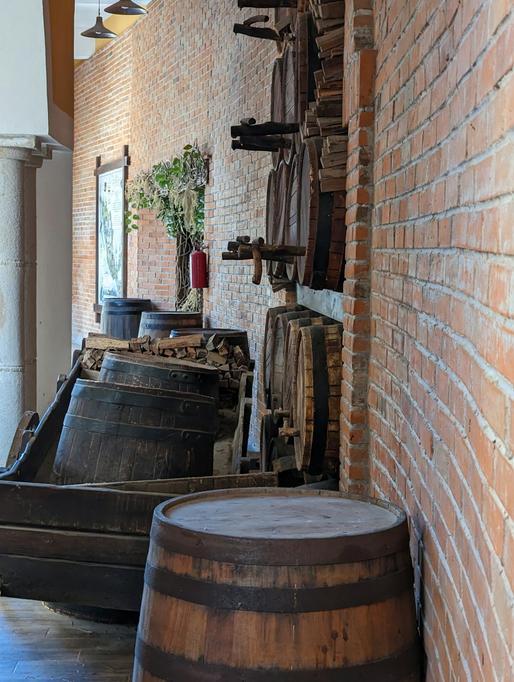 a room with a brick wall and a bunch of barrels