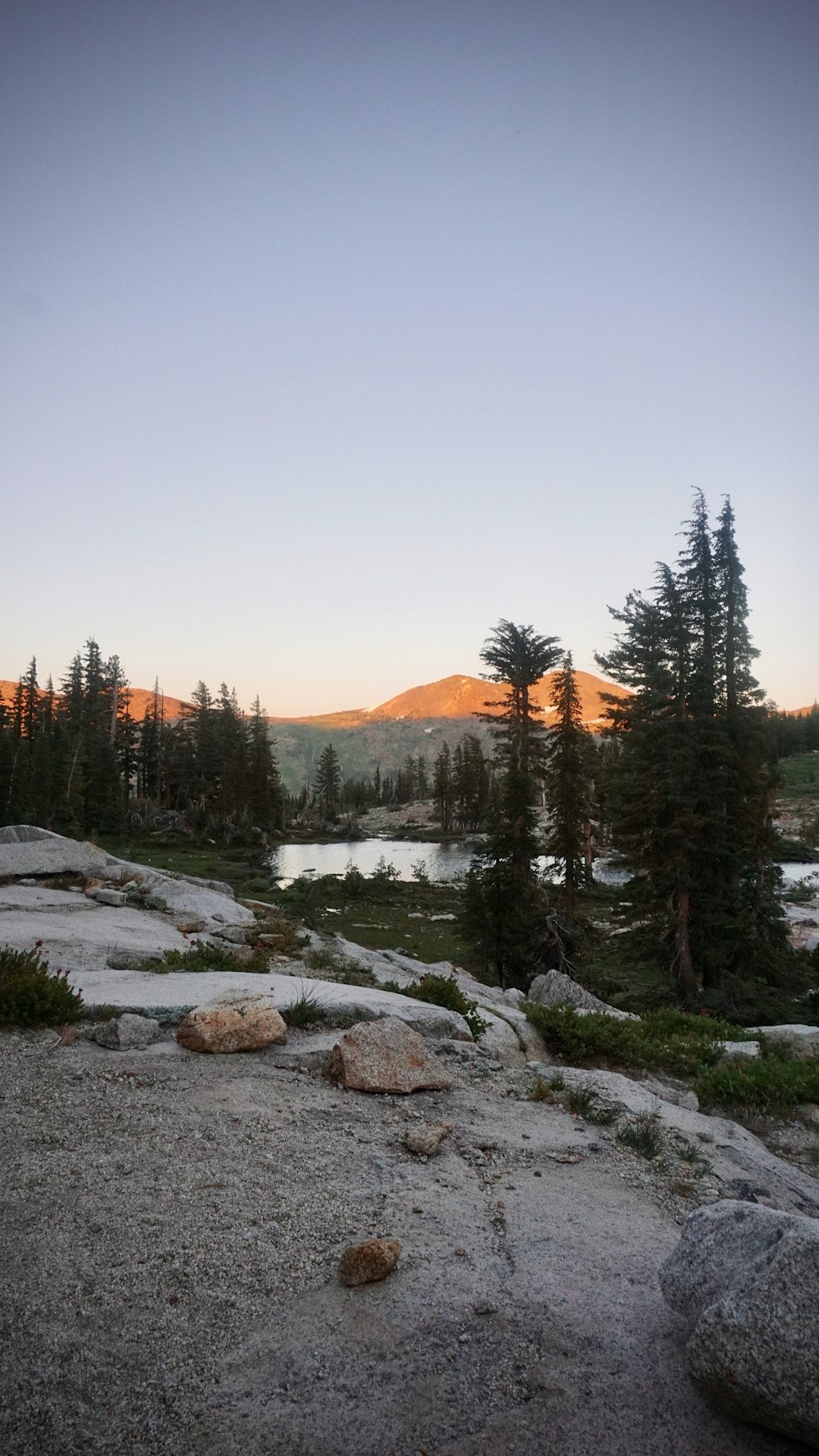 a lake surrounded by trees and rocks