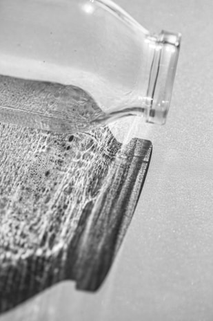 Close-up of an antique glass bottle with intricate patterns reflecting warm light.