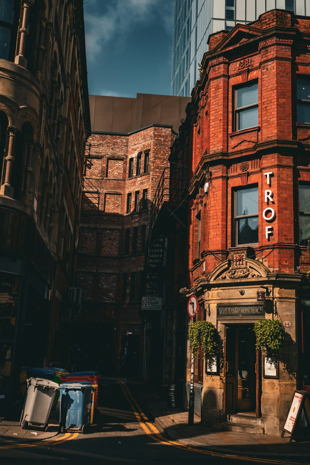 a tall red brick building sitting next to a tall building