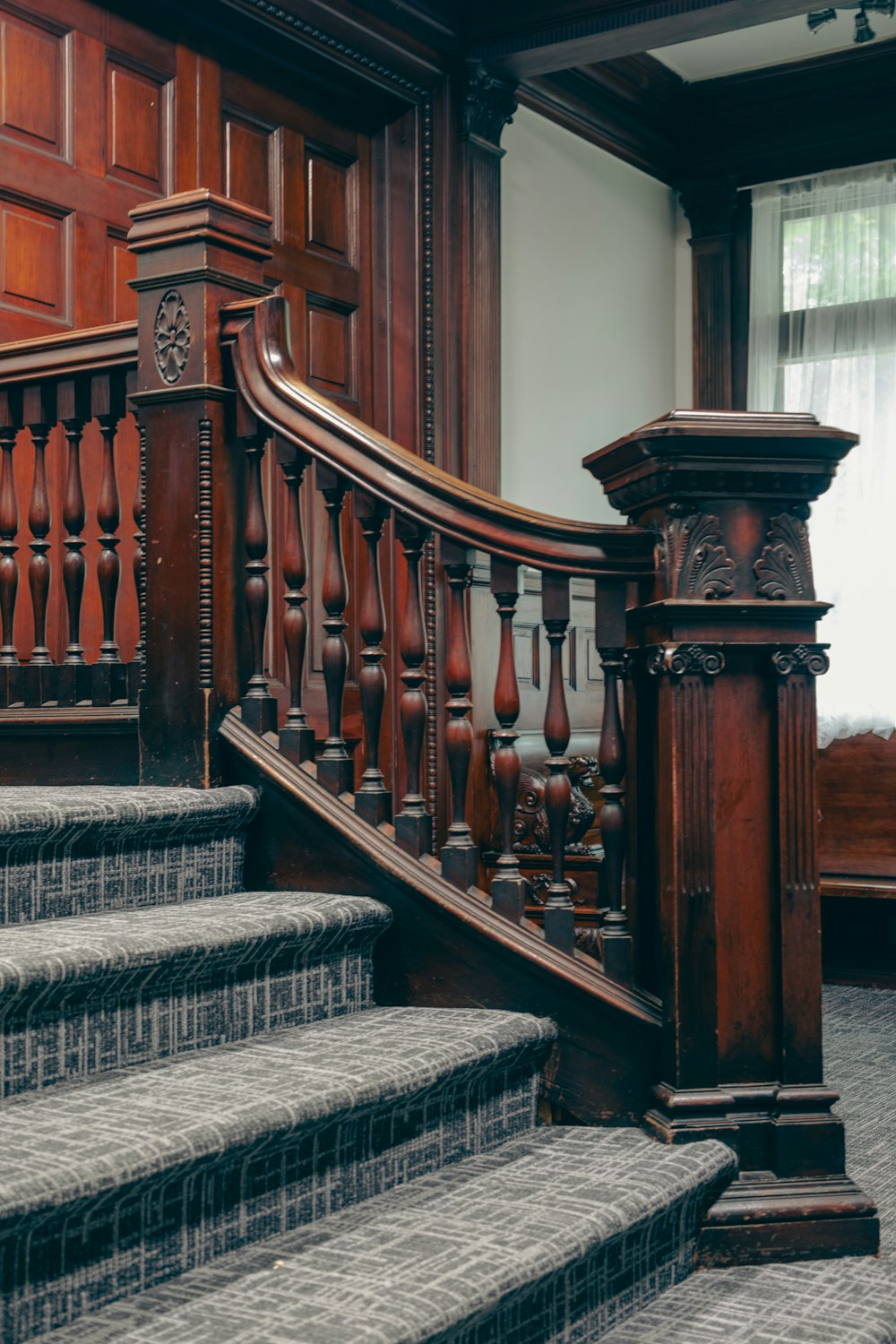 a set of stairs in a building with wood paneling