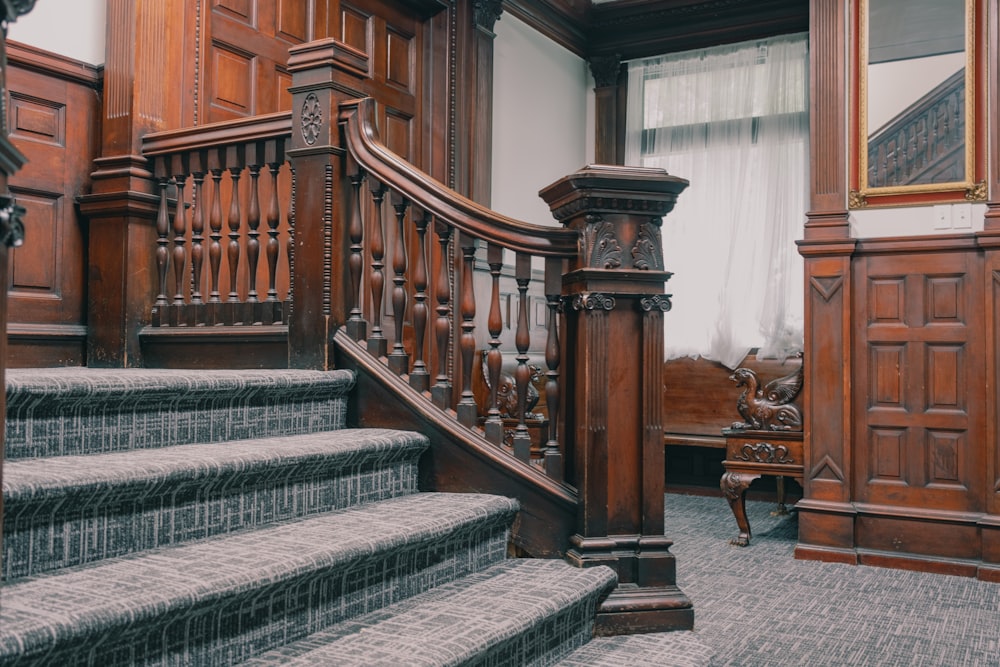 a staircase in a large room with wooden paneling