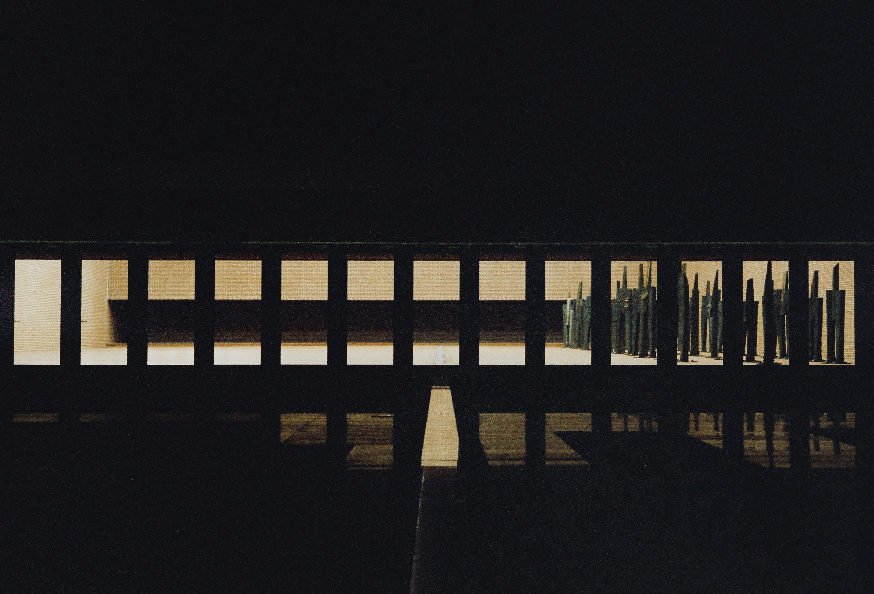 a bench sitting in the middle of a dark room