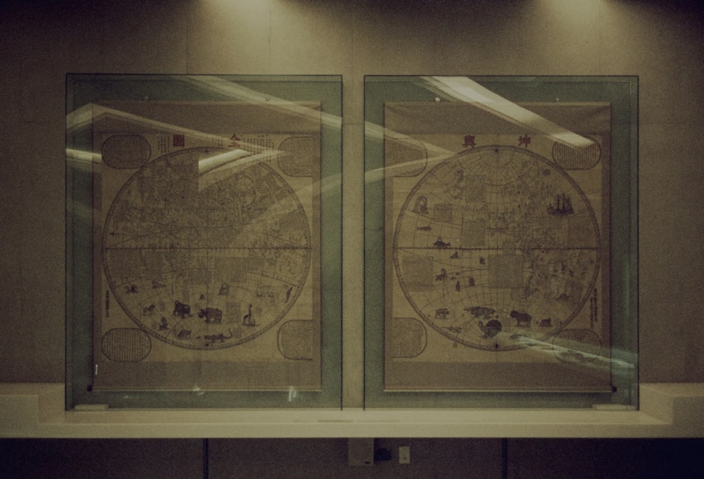 two framed maps on a wall in a room