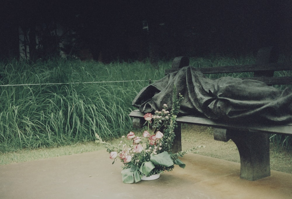 a bouquet of flowers is sitting on a bench