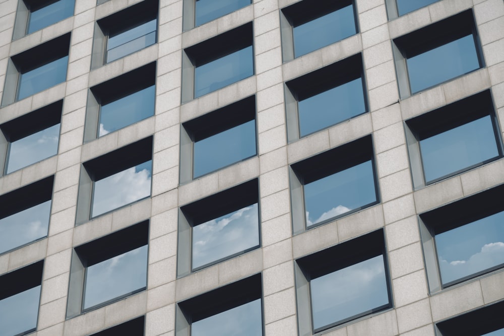 a tall building with lots of windows and a sky background