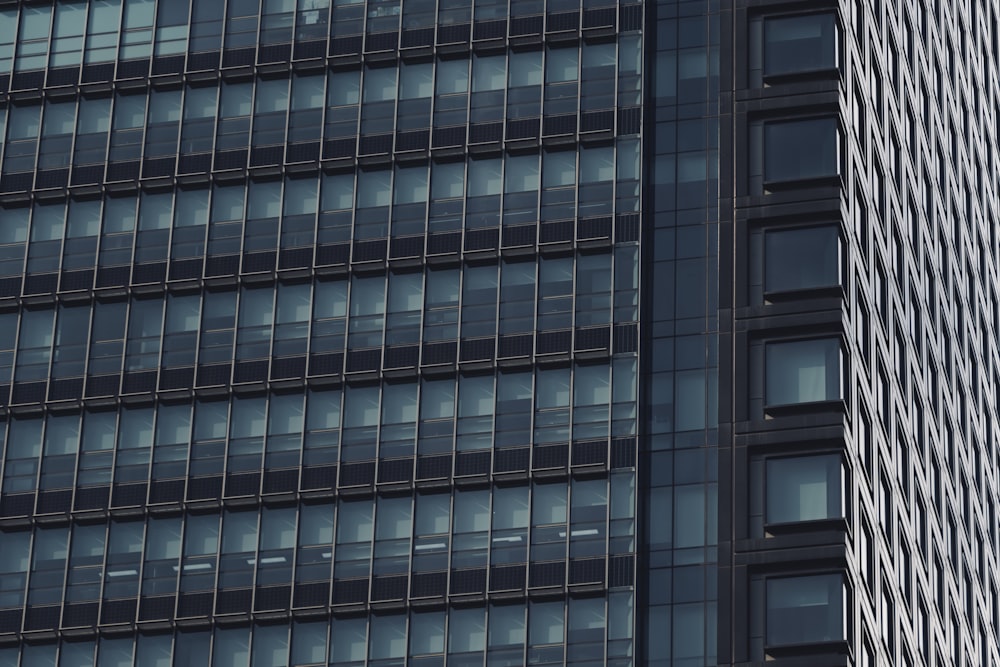 a plane flying in the air near a tall building