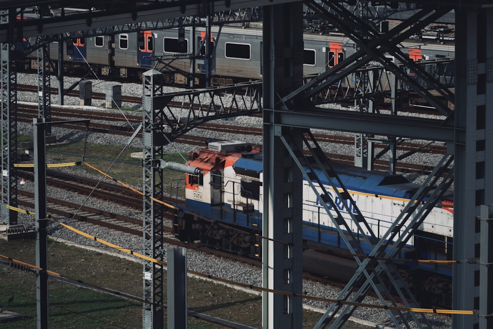 a train traveling down train tracks next to another train