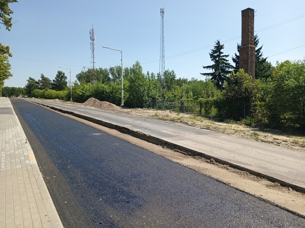 a road with a large pile of dirt on the side of it