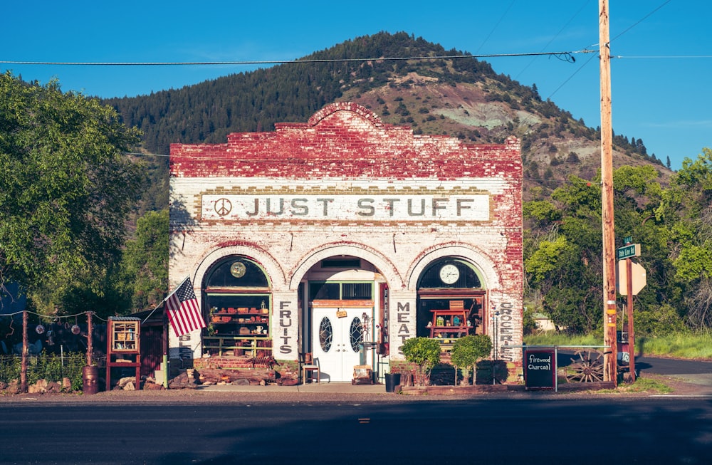 a red and white building sitting on the side of a road