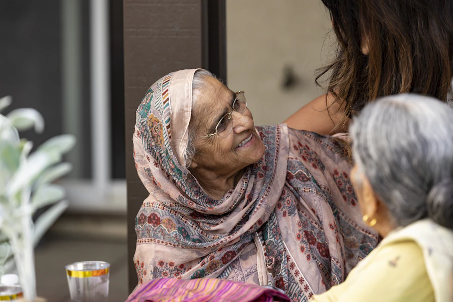 A smiling Indian grandmother sharing a warm moment with a family member